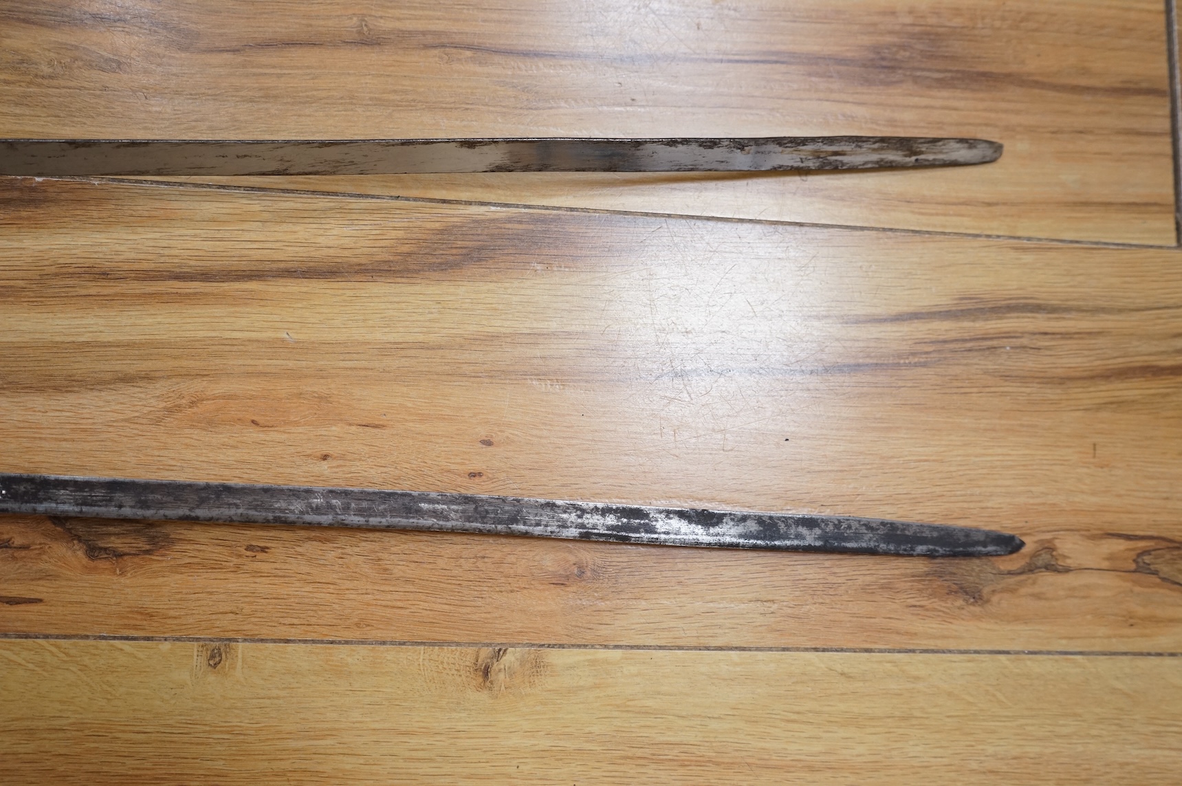 Two early 20th century Imperial German child’s swords with leather scabbards and hangers, blades 45.5cm